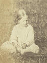 Girl seated in a field